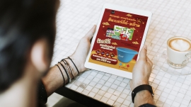 Man at a coffee shop using a tablet mockup